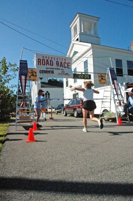Crossing the Finish Line
Karen Regan of Somerset, MA, crosses the finish line in the First Annual Rochester Road Race held on Saturday, August 12 in anticipation of this weekends Annual Country Fair. Ms. Regan was the womens overall winner with a finish time of 22:06. (Photo by and courtesy of Angela Kantner).
