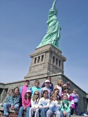 Escape to New York
The girls of Mattapoisett Brownie Troop #75 recently escaped for a trip to New York City on April 14 where they visited the Statue of Liberty and posed with a copy of The Wanderer at the base of the monument. (Photo courtesy of Brownie Leader Sandy Thomas).

