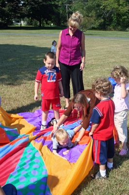 Tri-Town Toddlers
Children participate in a washing machine game that involves taking a ride through the wash cycle using a parachute during the Tri-Town Early Childhood Councils Teddy Bear Picnic held on Saturday, September 22 at the scenic Great Hill Farm in Marion. The event, designed to introduce parents to the areas early childhood programs, was held on the lawn of a castle-like mansion overlooking Buzzards Bay. (Photo by Robert Chiarito).
