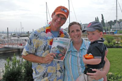 FOX 25 Crew in Marion
FOX 25 Morning News Co-Anchor Gene Lavanchy poses with a copy of The Wanderer alongside Margie Souza of Fairhaven and her nephew John Duffy during the recent Zip Trip remote broadcast in Marion. (Photo by Kenneth J. Souza).
