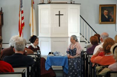 High Tea and Gossip
Lucy Bly and Katherine Gaudet played the roles of two gossiping ship captains wives for the Mattapoisett Museum and Carriage Houses High Tea and Historic Gossip session held on Sunday, March 11. The creative program was an informal way of discussing historic events and tidbits of local gossip from the 1860s while being treated to a lively performance from the role-playing characters. (Photo by Robert Chiarito).
