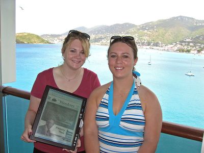 Glad Grads
Holly Smith and Kerrin Souza pose with an electronic copy of The Wanderer on a tablet computer during a recent Caribbean cruise with Saint Thomas, USVI in the background. The cousins received the cruise as a graduation gift. (Photo by and courtesy of Tim Smith).

