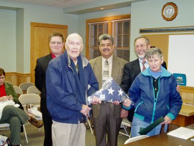 Old Glory in Mattapoisett
Mattapoisett Selectman Jordan Collyer, Mr. Arthur C. Potter, Selectman Steve Lombard, Selectman Ray Andrews, and Mrs.Cecilie C. Potter, pose with the American flag recently presented to the Town of Mattapoisett by their son, Gunnery Sergeant Caleb C. Potter, USMC, 2nd Marine Division. This flag flew over Camp Blue Diamond, Ar Ramadi (Provincal Capital) Al Anbar, Province of Iraq, on Veterans Day, November 11, 2005, and will be kept on display in the Mattapoisett Town Hall. (Photo courtesy of Ray Andrews).
