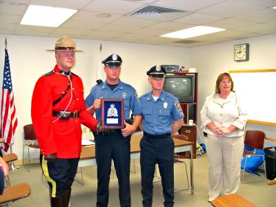 Police Commendation
Constable Greg Lupson of the Major Crime Unit of the Royal Canadian Mounted Police recently presented Mattapoisett Patrolman Andrew Murray, Sergeant Jason King, and Police Chief Mary Lyons with an award from Canadian authorities for their great teamwork and quick thinking in apprehending Gregory Despres on the night of April 26, 2005. (Photo by Nancy MacKenzie).
