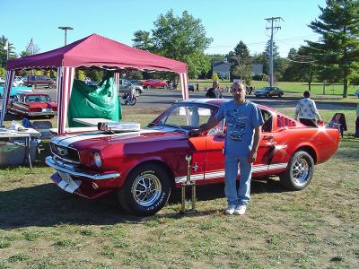 Hot Rods in Rochester
Louis Aiello Jr. poses alongside his award-winning 1966 Ford Mustang Fastback which recently took the first place trophy in the 2006 Plumb Corner Hot Rod and Custom Car Show in Rochester. The annual event draws over 100 participants each year with proceeds benefitting the A Wish Come True organization.
