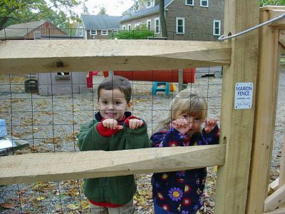 Mending Fences
Two students from the Loft School in Marion pose behind the new fence which was erected at the playground they use at Saint Ritas Parish. The playground, located at the corner of Front Street and Vine, is now in the process of undergoing much-needed improvements and renovations. All of this years fund-raising efforts at the Loft School will go towards further improvements to the playgound. Anyone interested in donating funds to this much loved space should contact the Loft School at 508-748-1243.
