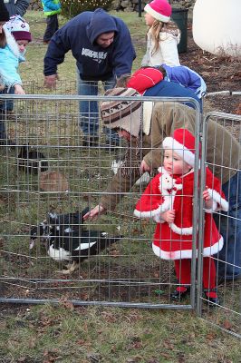 Santa's Helper
A child dressed like one of Santa's helpers enjoys seeing the animals in the petting zoo during Marion's annual Village Stroll held on Sunday, December 14. (Photo by Robert Chiarito).
