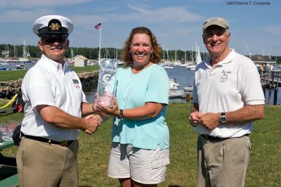 Good Win!
Wendy and Gordy Goodwin (middle and right) are presented with the E.L.Goodwin perpetual trophy from Harry Norweb, Vice Commodore of the Beverly Yacht Club (left) for winning their fourth National Bullseye Championship in five years which was hosted at the BYC. The first place trophy is named for Wendys grandfather, who was the original maker of the fiberglass Bullseye Sailboat. (Photo courtesy of Anne T. Converse).
