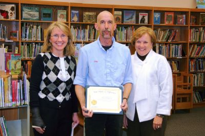 Chipping In
Sippican School staff member Charles Chip Phillips III (center) was awarded the Marion School Committee Recognition of Achievement on February 27 for designing and building a one-of-a-kind platform for the Project Grow classroom, specifically created for a student confined to a wheelchair. Chip also adapted a computer table so that the students wheelchair fits right into it. He is congratulated by Principal Dona Mahoney (right) and Chairman Jane McCarthy (left). (Photo courtesy of Brad Gordon).

