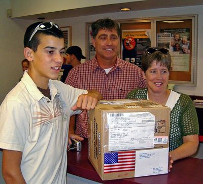 Handle With Care
Members of the Lynch Family, whose son PFC Daniel Lynch is serving in Afghanistan, help ship out the 2000th care package as part of the Cape Cod Cares for the Troops effort which Mattapoisett Boy Scout Troop 53 has taken on as an ongoing project. The troop still maintains a collection location at Mailbox Services on Route 6 in Mattapoisett and encourages donations. (Photo courtesy of Ron Ellis).
