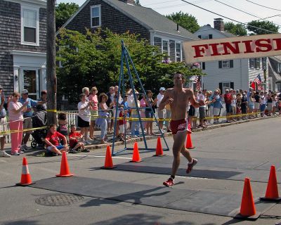 2007 Mattapoisett July 4 Road Race
Patrick Hoye of Sutton, MA crosses the finish line in the 37th annual July 4 Road Race, finishing second overall in 27:41 with a pace of 5:33. (Photo by Kenneth J. Souza).
