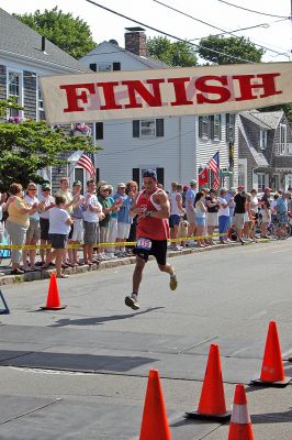 2007 Mattapoisett July 4 Road Race
Angel Martin of New Bedford crosses the finish line in the 37th annual Mattapoisett July 4 Road Race, finishing ninth overall in 29:55 with a pace of 5:59. (Photo by Kenneth J. Souza).
