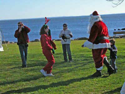 Here Comes Santa Claus
Santa arrives in Shipyard Park during Mattapoisett's first annual Holiday Village Stroll on Saturday, December 2. Santa also brought along Mrs. Claus, his helpful elves, Rudolph the Red-Nosed Reindeer, and Frosty the Snowman to delight children during the festivities. (Photo by Robert Chiarito).
