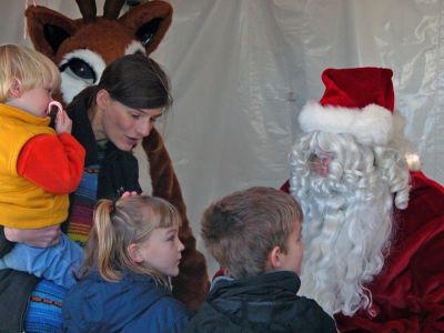 Secret Santa
Eager children ask Jolly Ol' Saint Nicholas for some of their wish-list items for Christmas during Mattapoisett's first annual Holiday Village Stroll at Shipyard Park on Saturday, December 2. (Photo by Robert Chiarito).
