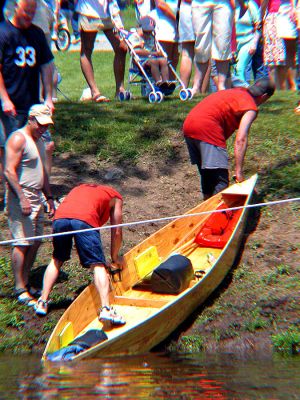 Land Ho!
Weary contestants in the 2006 Annual Memorial Day Boat Race on the Mattapoisett River heave their wooden boat from the water after crossing the finish line. (Photo by Kenneth J. Souza).
