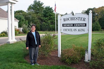 COA Director Honored
Rochester Council on Aging (COA) Director Sharon Lally poses outside the Rochester Senior Center on Dexter Lane. The Senior Center is being recommended for accreditation by the Senior Center Accreditation On-Site Peer Review Board  a distinction only 300 Senior Centers have achieved nationwide  and Ms. Lally was recently chosen as the Massachusetts Council on Aging Director of the Year. (Photo by Robert Chiarito).

