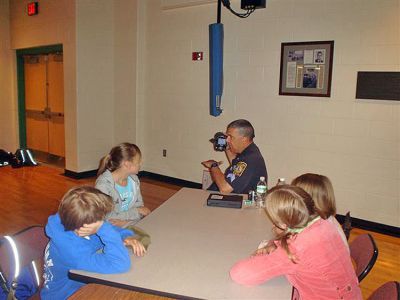 Career Day
Marion Police Sergeant Marshall Sadeck shows fifth grade students at Sippican School one of the types of equipment he uses during the recent Occupational Program at the school.

