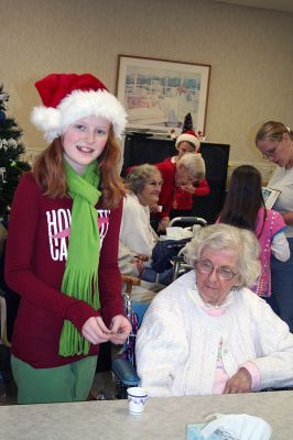 Spreading Holiday Cheer
Sixth grade student and Sippican School Council member Rachel McCoog was among a contingent of eighteen students from the Marion school who recently went to the Sippican Health Care Center to spread some Christmas cheer. The students spent the afternoon making ornaments with the residents, performing a skit, and serving refreshments and were accompanied by Enrichment Program advisors Stacey Soucy and Laura Dadagian ORourke. (Photo courtesy of Stacey Soucy).

