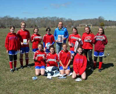Kick It Out
Stacey Bishop of the Boston Breakers soccer club poses with members of the Mariners Youth Soccer team and a copy of the Wandererthis past weekend in Fairhaven. Pictured are; Back row: L  R: Syd Blanchard, Morgan Browning, Kristen Fuller, Caroline Downey Stacey Bishop, Nicole Gifford, Camille Filloramo and Emily Beaulieu. Front Row L  R: Bailey Truesdale, Arden Goguen, Kaleigh Goulart and Sam Blanchard.
