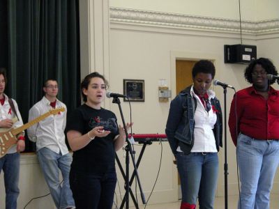 Swazi Aid Show
R&B singer Joy and her band performed during the first in a series of local benefit concerts at the Mattapoisett Congregational Church on Sunday, April 29. The show was organized by Mattapoisett resident and ORR graduate Sarah DeMatos (seen here introducing the group), who is attempting to raise money and awareness for abandoned children in Africa. (Photo by Robert Chiarito).
