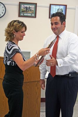 Dispatcher Honored
Rochester Chief Dispatcher Tracy Eldridge receives the Thirteenth Annual Jeff Grossman 9-1-1 Telecommunicator of the Year Award from Daniel Grossman, son of the awards namesake, recognizing her as the states outstanding dispatcher for the past year. Ms. Eldridge was nominated by Police Chief Paul Magee for all her hard work and effort in running the towns unique civilian Communications Department. (Photo by Robert Chiarito).
