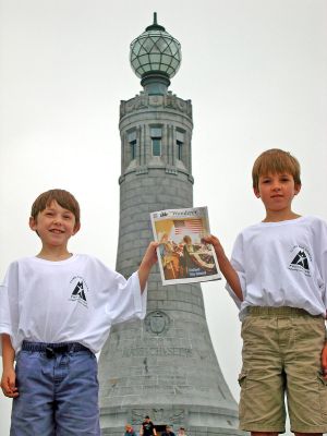 Peak Performance
Wiley and Chase Gibson of Marion pose with a copy of The Wanderer at Mount Greylock, the highest peak in Massachusetts at 3,491 feet. The Gibson family represented Massachusetts by climbing it as part of the 50-50-1 event (50 states, 50 peaks, 1 goal), a benefit for the Cancer Foundation held on June 26. (Photo by Lisa Gibson).

