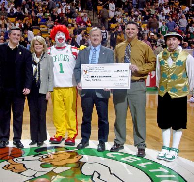 Clowning Achievement
The YMCA of the Southcoast in New Bedford was recently presented with a grant of $25,000 from Ronald McDonald House Charities (RMHC) of Eastern New England during halftime at a Boston Celtics game. Pictured (l. to r.) are Charlie Winterhalter, President, RMHC of Eastern New England and McDonalds Owner/Operator; Edie Stevenson, Executive Director, RMHC of Eastern New England; Ronald McDonald; Gary Schuyler, President, YMCA Southcoast; David Joseph, Executive Director, Dartmouth YMCA; and Lucky.
