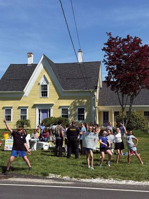 Lemonade Stand
Last Saturday, the 2026 Lemonade Stand in honor of Vivian Jones was open on New Bedford Road in Rochester. Friends of Vivi from Rochester Memorial School received tons of local support, as the kiddos raised nearly $2000 for the Dan-Farber & Kids PMC. In the foreground, looking at the camera from left to right: Timothy, Abby, Ruby, Ivy, Alice, and Grace. Photo by Sam Bishop - May 21, 2026 edition
