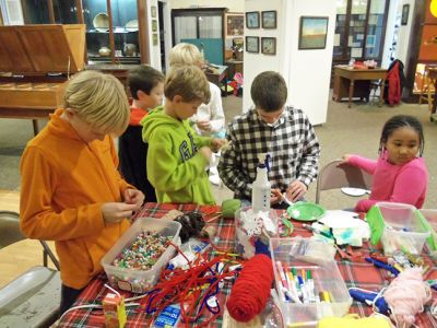Marion Natural History Museum
On Wednesday, Dec. 10th, the Marion Natural History Museum afterschool group enjoyed working on crafts from nature and recycled materials.  Thank you to all the volunteers who made this such a happy and fun-filled event. Many, many thanks to Grace Moran for her kind donation of frames complete with glass, which the students used to create their own masterpieces for gift-giving. Please keep checking the website for our upcoming list of after-school programs for 2015; www.marionmuseum.org.
