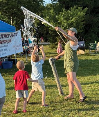 Marion Town Party
The annual Marion Town Party was on Saturday evening. Following a great day for the beach, residents pooled into the field by Silvershell Beach for their midsummer party, celebrating summer and community in the party that has gone on longer than anyone remembers. Bailey Sweet is seen making bubbles for local children. Photo by Shawn Sweet. July 30, 2026 edition
