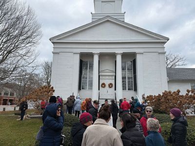 Veterans Day
Attendees to the Veterans Day celebrations in Mattapoisett this past Tuesday. They gathered at the front of the Mattapoisett Congressional Church to await the bells ringing at 11:00 am. As they waited, a few stray snowflakes drifted down from a white sky. Following that, they walked across the street to Center School for performances by the Showstoppers and The Old Hammondtown Band. Photo by Sam Bishop
