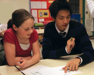 International Visit
Yi-Tsung "Eric" Chen of Taiwan shows fifth grader Lucy Saltonstall her name in Chinese on March 3, 2010 during a Mandarin Outreach class at Sippican School. Photo by Jane McCarthy.
