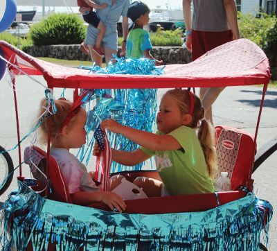 Marion's Independence Day Parade
Two girls celebrate America’s 250th in Marion with a flag and a carriage during the annual Marion Independence Day Parade on Saturday. The parade ran from the Town House up Main Street, down Spring, and circled back from Route 6 and Front Street. Photo by Mick Colageo
