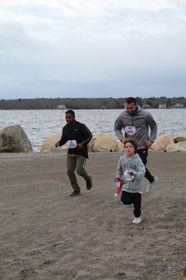 Mattapoisett Santa Stampede
The Mattapoisett Santa Stampede took place on Saturday, December 6 with over 300 Santas taking place. The 5K began at Shipyard Park and cut down Ned’s Point Road to the point, around the lighthouse and back. The Grinch led the pack on his bike, and residents stood by to cheer on all the runners. Photos by Sam Bishop and Mick Colageo
