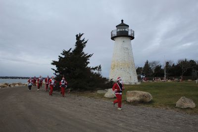 Mattapoisett Santa Stampede
The Mattapoisett Santa Stampede took place on Saturday, December 6 with over 300 Santas taking place. The 5K began at Shipyard Park and cut down Ned’s Point Road to the point, around the lighthouse and back. The Grinch led the pack on his bike, and residents stood by to cheer on all the runners. Photos by Sam Bishop and Mick Colageo
