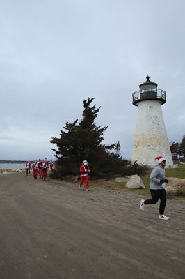 Mattapoisett Santa Stampede
The Mattapoisett Santa Stampede took place on Saturday, December 6 with over 300 Santas taking place. The 5K began at Shipyard Park and cut down Ned’s Point Road to the point, around the lighthouse and back. The Grinch led the pack on his bike, and residents stood by to cheer on all the runners. Photos by Sam Bishop and Mick Colageo
