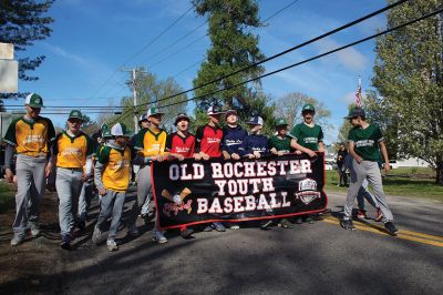 Opening Day of Old Rochester Youth Baseball
Opening Day of Old Rochester Youth Baseball brought out the crowds to hail the march from the Dexter Lane fields over to Gifford Park for ceremonies, including recognition for 12-year-old players entering their final year of little league. Photos by Mick Colageo
