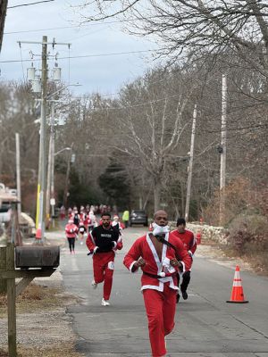 Mattapoisett Santa Stampede
The Mattapoisett Santa Stampede took place on Saturday, December 6 with over 300 Santas taking place. The 5K began at Shipyard Park and cut down Ned’s Point Road to the point, around the lighthouse and back. The Grinch led the pack on his bike, and residents stood by to cheer on all the runners. Photos by Sam Bishop and Mick Colageo
