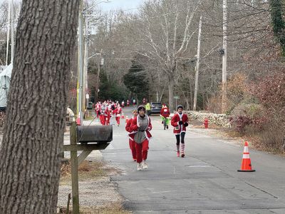 Mattapoisett Santa Stampede
The Mattapoisett Santa Stampede took place on Saturday, December 6 with over 300 Santas taking place. The 5K began at Shipyard Park and cut down Ned’s Point Road to the point, around the lighthouse and back. The Grinch led the pack on his bike, and residents stood by to cheer on all the runners. Photos by Sam Bishop and Mick Colageo
