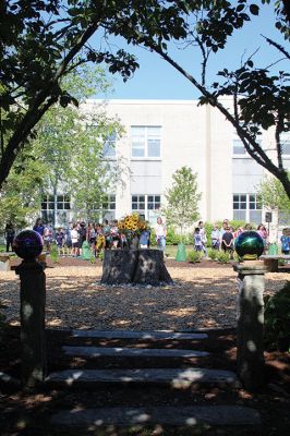 Children’s Memorial Garden
Where for many years stood a tall spruce tree at Sippican Elementary School is now a large stump at the center of a newly dedicated Children’s Memorial Garden honoring the lives of former students Marques Sylvia, Andrew Rego, Alexis Wisner and Cory Jackson. On June 14, Principal Marla Sirois led a celebration of the vision of former Principal Marylou Hobson (1990-2004) and the generosity and effort of Steve Gonsalves, Suzanna Davis, Margie Baldwin and the Pythagorean Lodge. Photos by Mick Colageo
