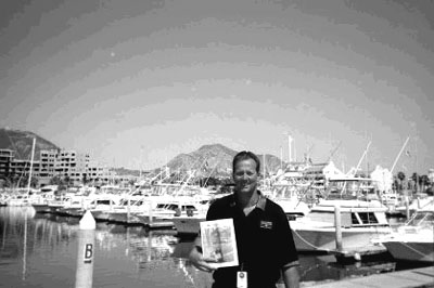 01-31-02-2
On a recent fishing trip to Cabo San Lucas, Chris Gay of Mattapoisett didn't leave home without it. His copy of The Wanderer, that is. Here he poses with it in Baja Mexico.  (Photo courtesy of Chris Gay). 1/31/02 edition
