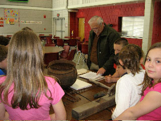 Rochester History
Rochester Historical Commission members presented a local history assembly to the 3rd grade a Rochester Memorial School. The presenters were, (top left)Fred Underhill displaying items from Stillwater Furnace, Henry Hartley showing pictures of local Native Americans, Cindy Underhill (spouse of RHC member) talking about the early cranberry industry, and Betty Beaulieu explaining about the early schools in Rochester and  Anna White showing artifacts from early churches, food and dress.
