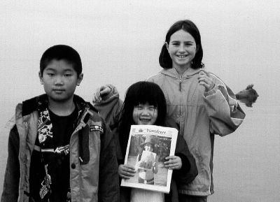 071504-2
Dillon and Kayla Bailey and Kelley Burke pose not only with their favorite tri-town publication, The Wanderer, but also with a visiting harbor seal (distant right, on a rock) during a recent visit to Mattapoisett shores. 7/15/04 edition

