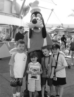 112504-2
The grandchildren of Thomas and Linda Tilden of Marion  Adam Carvalho, Selena Carvalho, Michael Edgerton, and Thomas Edgerton  pose with a copy of The Wanderer and a familiar Disney character while on vacation. (Photo by Laura Edgerton). 11/25/04 edition
