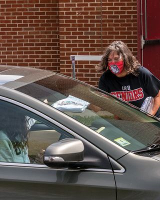 Class of 2020 
Graduating seniors in the Old Rochester Regional High School Class of 2020 drove around to the back of the school building on May 28, where they were greeted by faculty and administration. After arriving in order of homeroom to ensure safe spacing, the seniors turned in textbooks and received yearbooks, a surprise COVID-19 gift bag, and a long-sleeve t-shirt decorated with the mascot Bulldog and the word ‘Quarantine’ spelled across the front. Photo by Ryan Feeney
