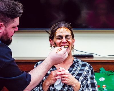 Decimated Designs
Kyle Pasciutti works on a haunted look for Heidi Leger during Tuesday night’s demonstration at the Mattapoisett Library, where the owner of Connecticut-based Decimated Designs turned local faces into living Halloween masks. Michelle Skaar of the library’s young adult programming invited the makeup artist for her teen group, but it quickly became apparent that mask making is a cross-generational activity. Pasciutti decided to pursue makeup when he was a theater art major in college. 
