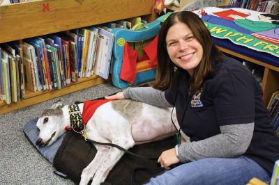 Amos the greyhound 
Amos the greyhound is new to Rochester and he and his owner ‘Ms. Holly’ have been looking to find his niche in the community. Since Amos is a trained therapy dog and he loves kids and books, he decided to hold an event at the Plumb Library on Thursday, January 12. Pictured here, Owen Perry reads to Amos who snuggled in closely.
