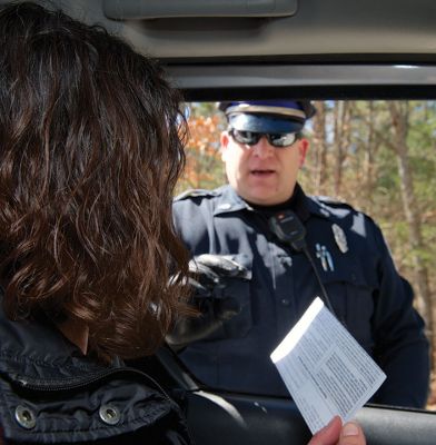 Busted!
Busted! Rochester Police Officer Robert Nordahl hands The Wanderer News Editor Jean Perry her vehicle registration back, just before cuffing her and placing her under “arrest.” Photo by Colin Veitch
