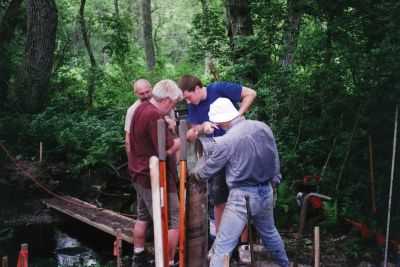 MLT Bridge
Mattapoisett residents Geoff King and Paul Osenkowski, along with Luke Buckley and Alex Buckley install the footbridge over a stream on a Mattapoisett Land Trust trail on July 3, 2010. Photo by Andrea Buckley.
