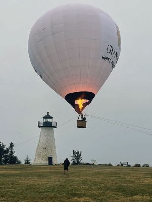 Ned's Point Balloon
Not a typical Saturday morning at Ned’s Point, where the Guinness promotional team finished up a St. Patrick's Day city tour that included Chicago, the Guinness brewery outside Baltimore, and New York before concluding in Mattapoisett. “The backdrop is gorgeous, the setting is another reason,” said Jeremy Hoar of the choice to use Ned’s Point as the Massachusetts location. Hoar, who works for public-relations company MKTG, said that SkyCab Balloons Promotions, Inc. Photo courtesy of Faith Ball
